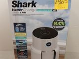 the box of a shark air purifier is open on the floor
