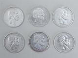 six different types of silver coins are shown on a white surface