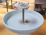 a water fountain with a flower on top of it