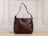 a brown purse sitting on top of a wooden table next to a wall