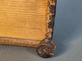 a small wooden box with a metal handle on a table