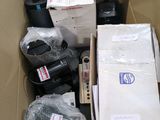 a cardboard box full of assorted electronics and other items