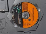 a cd that is sitting on top of a laptop