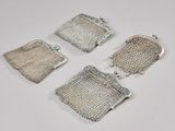 three silver mesh purses on a white surface