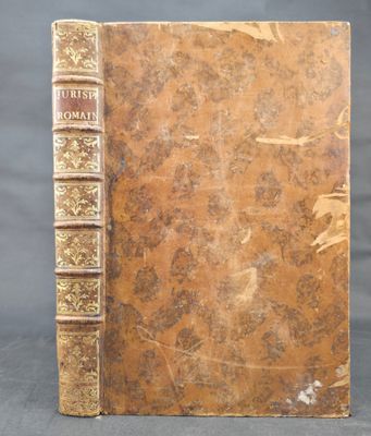 an old book sitting on top of a table next to a black background