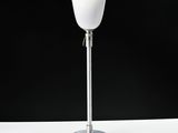 a close up of a lamp on a table with a black background