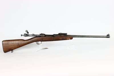 an old rifle with a wooden barrel on a white background