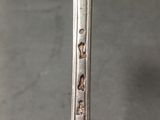 a close up of a silver spoon with a handle on a table