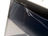 a broken laptop computer sitting on a table
