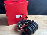 an image of a pair of headphones sitting on top of a wooden table