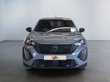 the front view of a grey car in a showroom