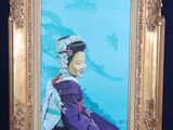 a painting of a woman in a purple dress on a easel