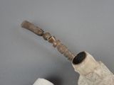a pipe with a wooden handle next to a roll of toilet paper