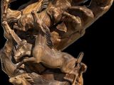 statue of a horse and rider on a wooden base with a black background