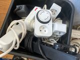 a black container with a bunch of electrical cords in it