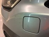 a close up of a car ' s front bumper with scratches on it