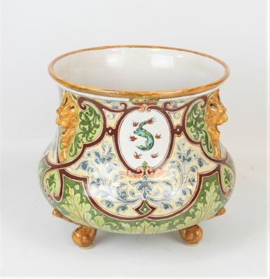 a green and yellow vase with a bird on it