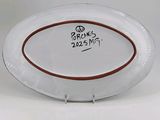a white plate with a brown border on it
