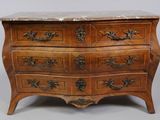 an old wooden chest of drawers with marble top