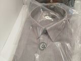 a box with a shirt in it that is wrapped in plastic