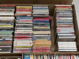 a lot of dvds in a box on the floor
