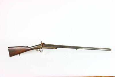 two guns are on a white surface next to each other