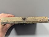 someone is holding a piece of wood that has been placed on a table