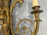 an image of a gold colored wall sconce with a candle on it