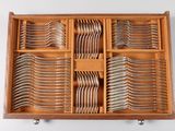 a lot of forks and spoons in a wooden box