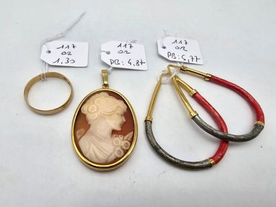 three rings and a pendant with a picture of a woman and a pair of pliers