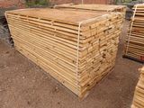 several stacks of lumber stacked on top of each other in a yard