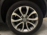 a close up of a tire on a car in a garage