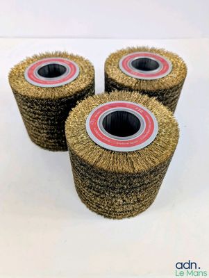 three wheel brushes are sitting on top of each other