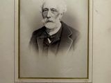 an old photo of a man with a beard and glasses
