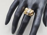 an image of a woman ' s hand with a gold ring on it