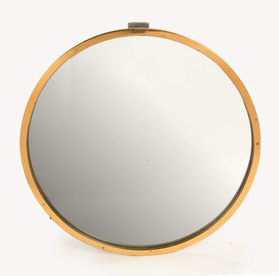 a round mirror with a gold frame on a white background