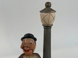 a statue of a man with a top hat and a cane