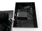 a black box with some wires and a remote control