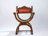 a wooden chair with a red cushion on top of it