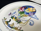 many plates with different designs on them on a table
