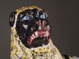 a statue of a dog with a collar on it ' s neck