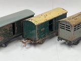several toy trains are lined up in a row on a white surface