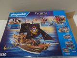 a box with a pirate ship in it on a table
