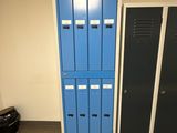 two blue lockers in the corner of a room