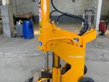 a close up of a forklift in a warehouse on a pallet