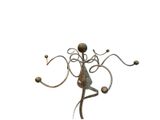 a metal sculpture of a woman with a ball in her hand