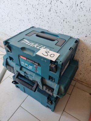 a blue tool box sitting on the floor next to a wall