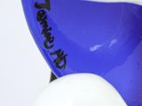 a close up of a blue and white vase with a white handle