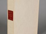 an image of a white book with a red label sitting on a table