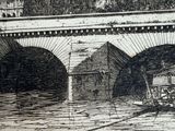 a black and white drawing of a train going under a bridge
